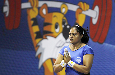 India's Srishti Singh gestures after her successful attempt in the women's 75kg weightlifting competition on Saturday