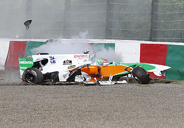 Force India's Liuzzi car rams into the wall after colliding with Ferrari's Massa