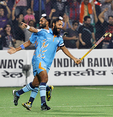 India's hockey players Sarvanjeet Singh (left) and captain Raj Pal Singh celebrate after scoring against Pakistan on Sunday