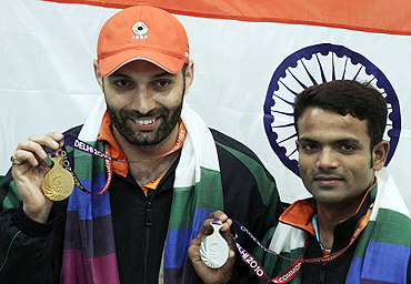 India's gold medallist Harpreet Singh (left) and silver medallist Vijay Kumar after winning the men's single 25m centrefire pistol shooting final on Sunday