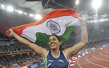 India's Krishna Poonia celebrates her gold medal feat in the women's discus event on Monday