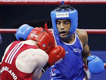 India's Dilbag Singh (blue) lands a punch on Northern Ireland's Patrick Gallagher during their semi-final men's 69kg boxing match on Monday