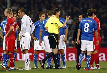 Referee Thomson gestures after suspending the Euro 2012 qualifying match between Italy and Serbia