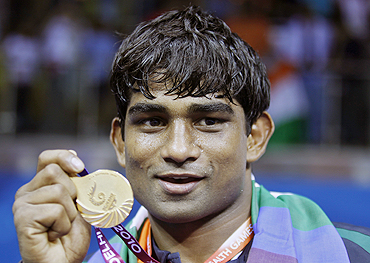 India's Paramjeet Samota poses with his gold medal on Wednesday