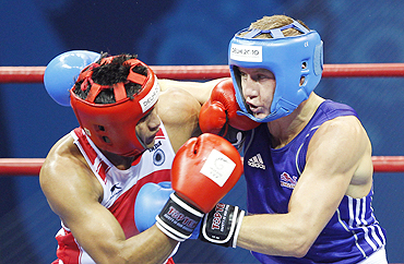 India's Manoj Kumar (left) lands a punch on England's Bradley Saunders during their final on Wednesday