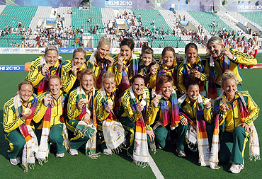 Australia's players pose after clinching the gold medal after the women's field hockey final on Wednesday