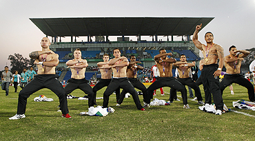 New Zealand players perform the Haka after receiving their gold medals for winning the rugby sevens final