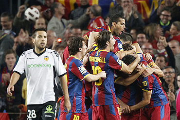 Barcelona players celebrate after Puyol's goal