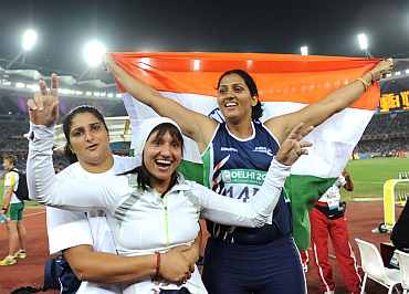 India's Krishna Poonia, Harwant Kaur and Seema Antil celebrate after winning medals