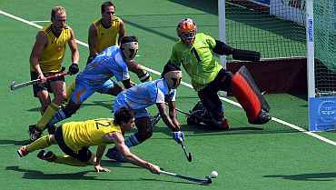 Australia's Trent Mitton (12) hits a goal against India during their men's field hockey final match
