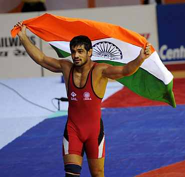 Sushil Kumar with the Indian flag after winning a gold medal