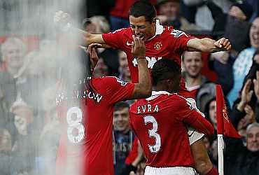 Javier Hernandez celebrates with team-mates after scoring a goal