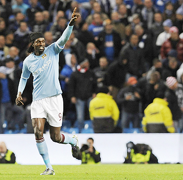 Manchester City's Emmanuel Adebayor celebrates his second goal against Lech Poznan