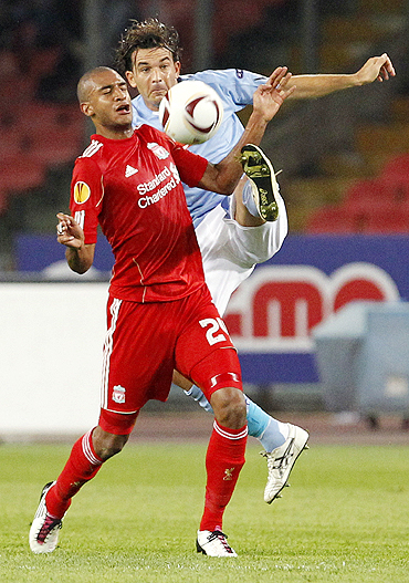 Liverpool's David Ngog (left) and Napoli's Salvatore Aronica vie for possession during their Europa League match