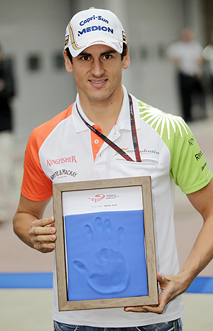 Force India Formula One driver Adrian Sutil of Germany displays a cast of his hand for the Driver Wall of Fame exhibition in Yeongaw at the South Korean GP