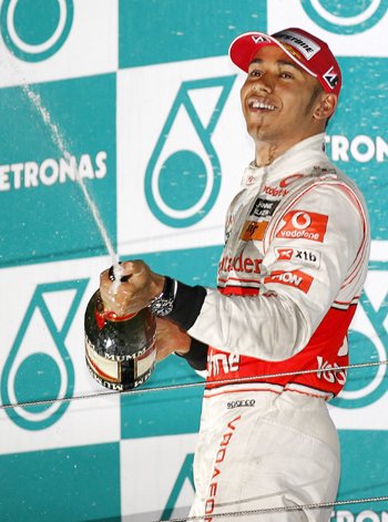 McLaren Formula One driver Lewis Hamilton of Britain sprays champagne as he celebrates on the podium after the South Korean F1 Grand Prix