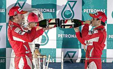 Ferrari's Fernando Alonso and Felipe Massa celebrate after winning South Korean F1 Grand Prix