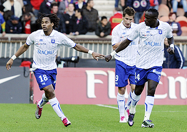 Auxerre's Jean Dennis Oliech (left) celebrates with teammates after scoring against Paris St Germain during their Ligue 1 soccer match on Sunday