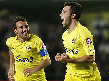 Villarreal's Giuseppe Rossi (right) celebrates with teammate Santiago Cazorla after scoring against Atletico Madrid on Sunday