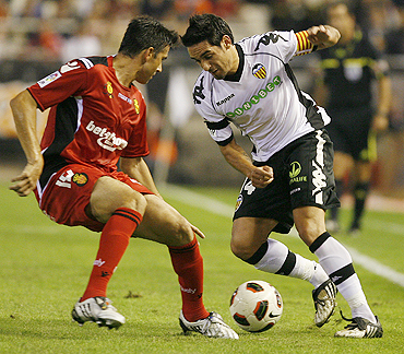 Valencia's Vicente Rodriguez (right) and Real Mallorca's Jose Luis Marti are involved in a duel during their La Liga match on Saturday