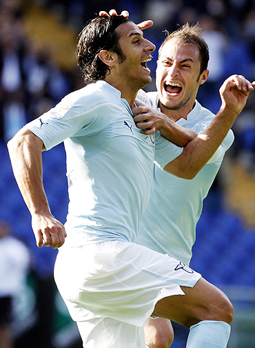 Lazio's Sergio Floccari (left) celebrates with teammate Stefan Radu after scoring against Cagliari on Sunday
