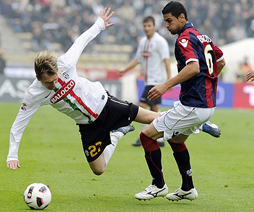 Juventus' Milos Krasic (left) and Miguel Britos of Bologna vie for possession during their Serie A match on Sunday
