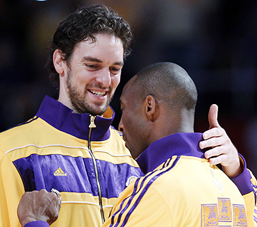Los Angeles Lakers Kobe Bryant (right) hugs teammate Pau Gasol after receiving their NBA Championship rings from NBA Commissioner David Stern in Los Angeles on Tuesday