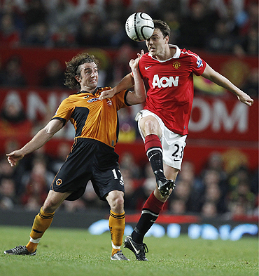 Manchester United's Jonny Evans (right) challenges Wolverhampton Wanderers' Stephen Hunt