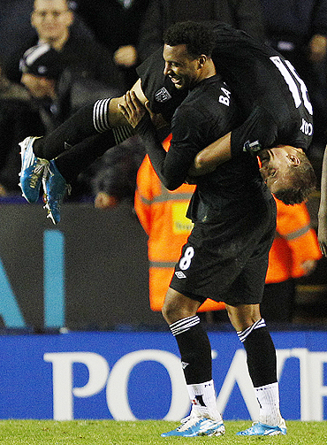 West Bromwich Albion's Simon Cox (right) celebrates his second goal against Leicester City with Giles Barnes
