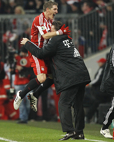 Bayern Munich's Bastian Schweinsteiger celebrates with coach Louis van Gaal after scoring against Werder Bremen on Tuesday