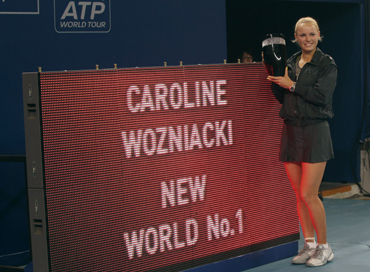 Caroline Wozniacki posses with the women's world number one trophy after defeating Petra Kvitova of the Czech Republic at the China Open