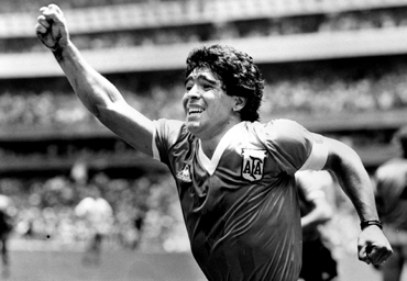 Diego Maradona raises his arm after scoring the winning goal against England