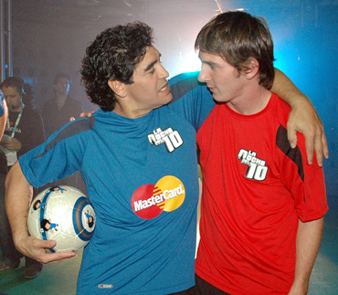Diego Maradona (L) hugs Lionel Messi of Spain's Barcelona during his weekly television show The Night of the 10 in Buenos Aires