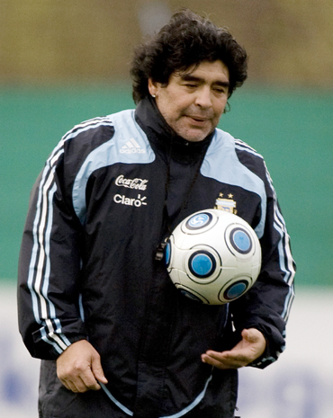 Diego Maradona holds a ball during a training session at the squad's camp in Buenos Aires