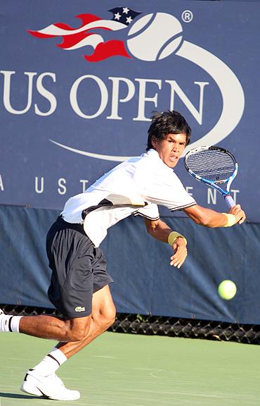 Somdev Devvarman returns during his first round match against South Africa's Kevin Anderson