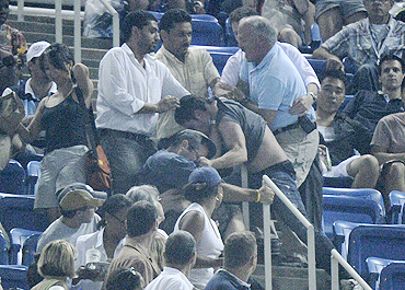 A fight breaks out in the stands during the match between Novak Djokovic and Philipp Petzschner