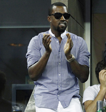 Musician Kanye West cheers from a private box