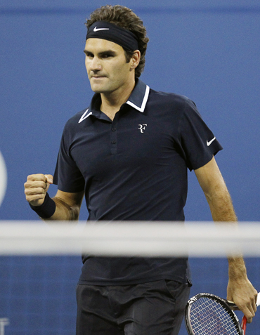Roger Federer of Switzerland celebrates after beating Robin Soderling of Sweden