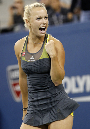 Caroline Wozniacki of Denmark celebrates defeating Dominika Cibulkova of Slovakia
