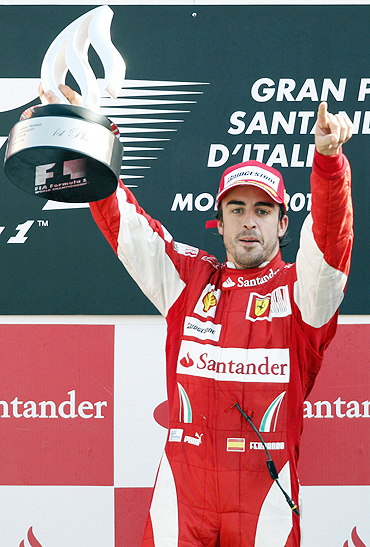 Fernando Alonso celebrates after winning the Italian GP