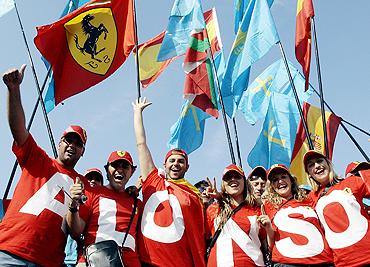 Fans of Fernando Alonso cheer during the Italian GP in Monza