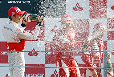 Jenson Button (left), Fernando Alonso and Felipe Massa (right) celebrate on the podium