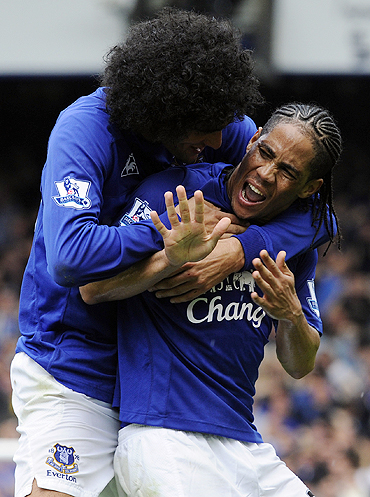 Everton's Steven Pienaar (right) celebrates with a teammate after scoring