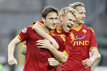 AS Roma's Francesco Totti (left), John Arne Riise and Philippe Mexes (right)