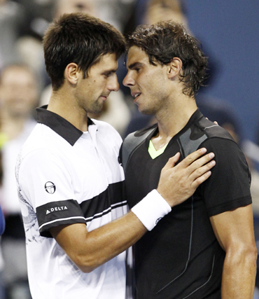 Rafael Nadal of Spain (R) hugs Novak Djokovic of Serbia after Nadal won