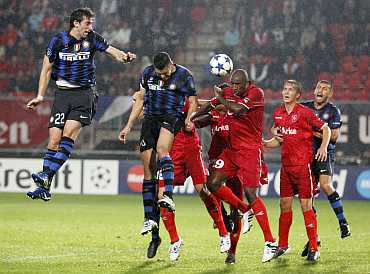 Diego Milito scores an own goal against Twente