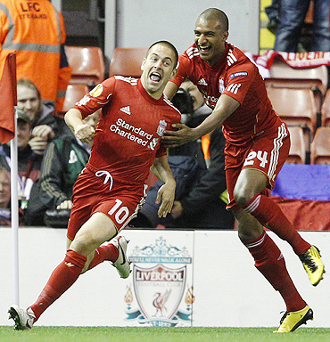 Liverpool's Joe Cole (left) celebrates with David Ngog after scoring against Steaua Bucharest