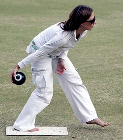 Yvonne Derksema plays a shot during a game of barefoot lawn bowls at a bowling club in Manly in Sydney