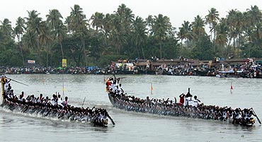 Oarsmen row their boat at the Nehru boat race in Alleppy district