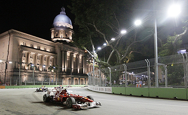 Ferrari Formula One driver Fernando Alonso powers around turn 10 in front of the Old Supreme Courthouse during the Singapore F1 Grand Prix
